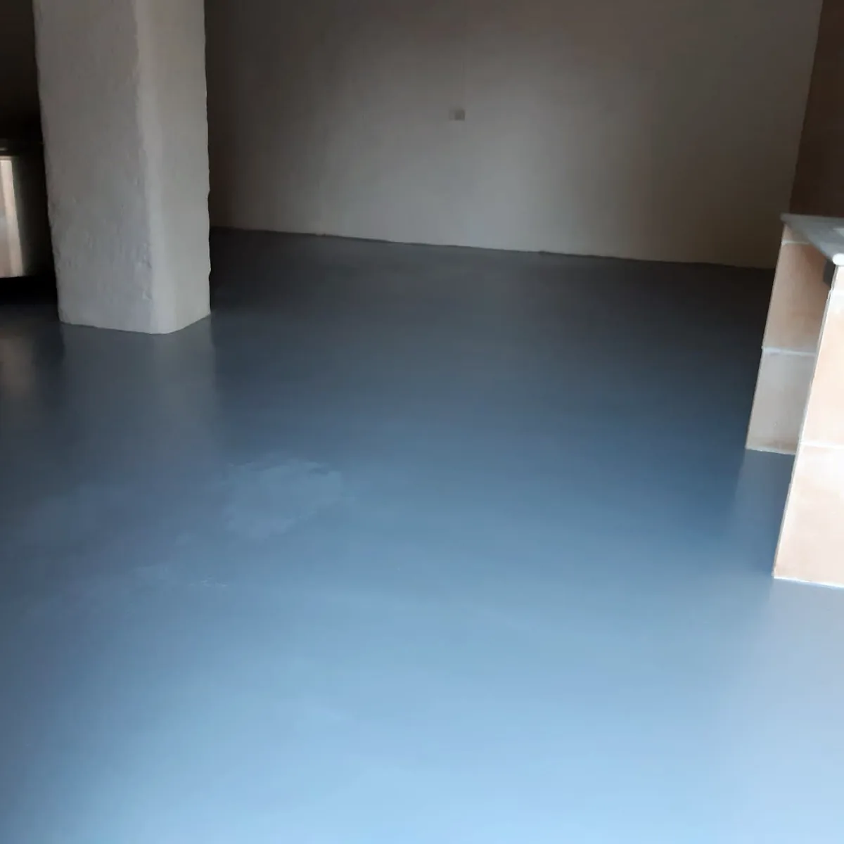 Empty cellar room with a smooth grey floor and a pillar, Maó Empty cellar room with a smooth grey floor and a pillar, Maó